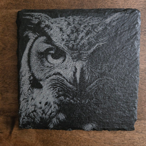 Slate Coaster with engraved owl on a wooden surface