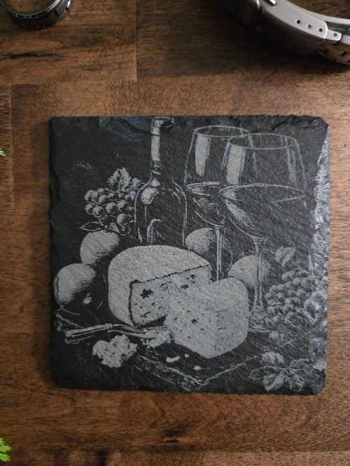 Slate coaster with engraved design of a still life scene 